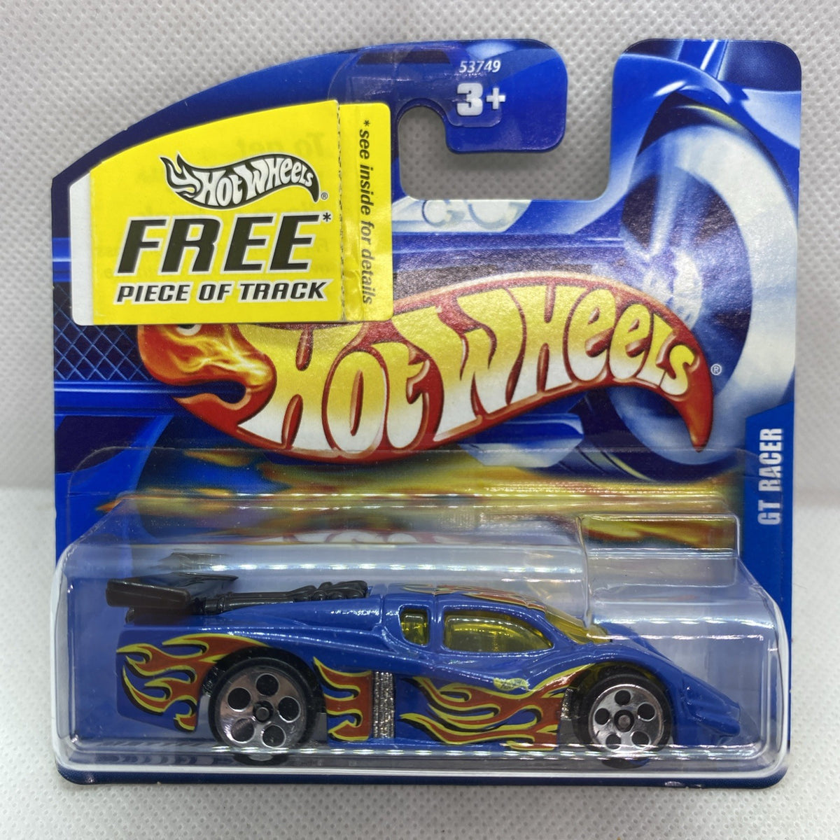 Hot Wheels GT Racer 2001 blue die-cast car blister card, flame decals, silver wheels.