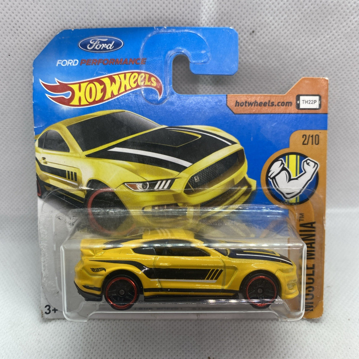 Yellow Hot Wheels muscle car in clear blister on blue card, front view