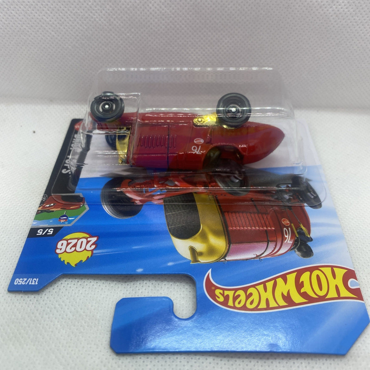 Hot Wheels red drop-top die-cast car with black wheels in blister