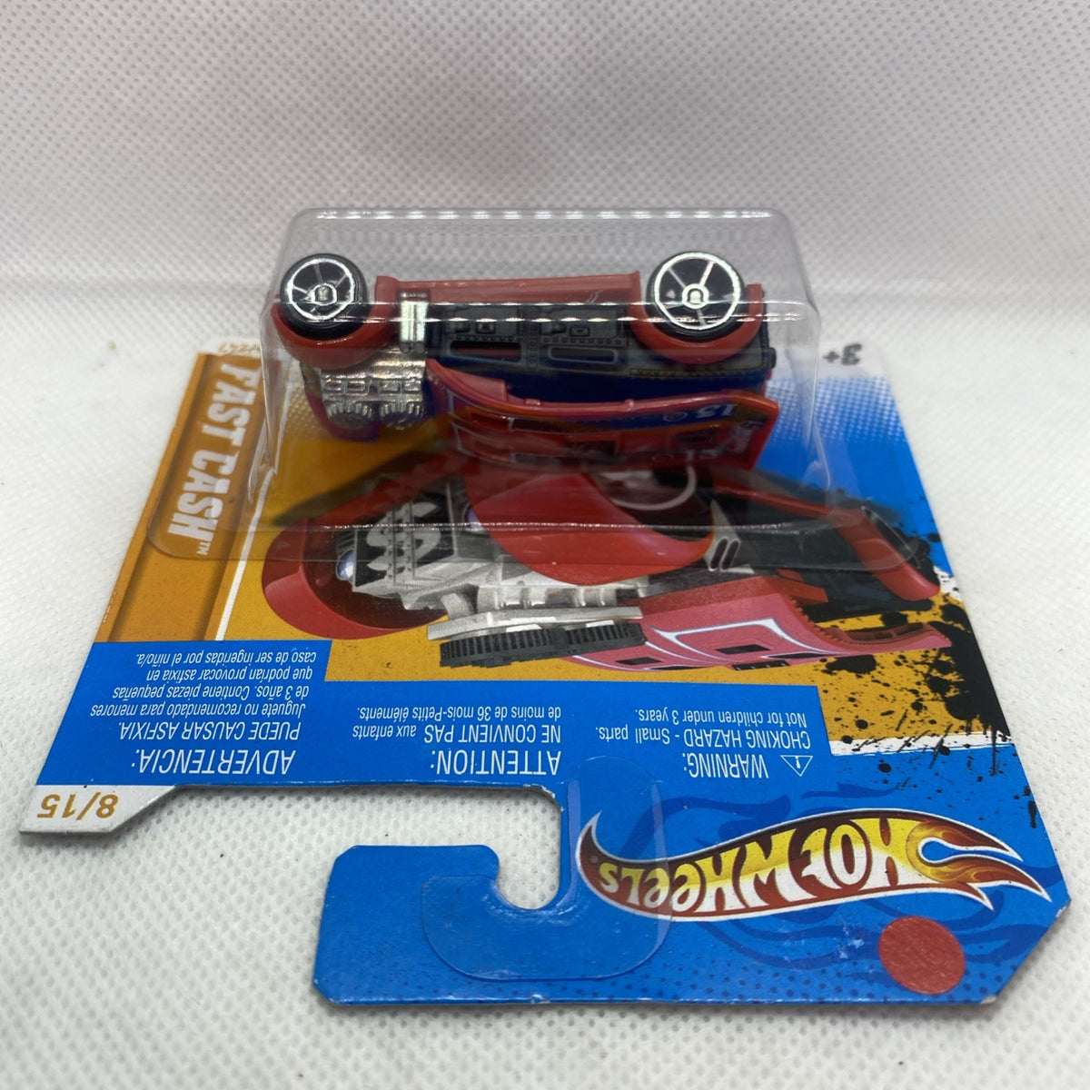 Hot Wheels diecast car, red body and silver engine, seen from top in sealed blister