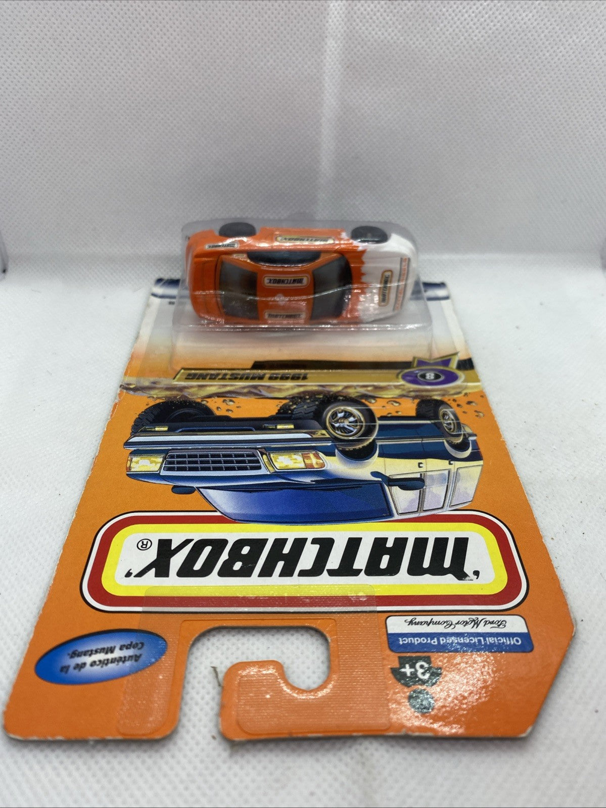 Matchbox blister pack top view with orange 1999 Mustang die-cast car