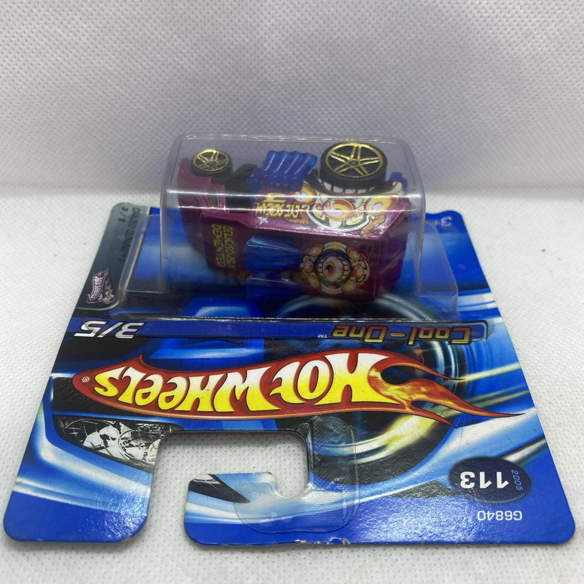 Hot Wheels Cool-One 2005 blister card, top view of magenta and blue die-cast car