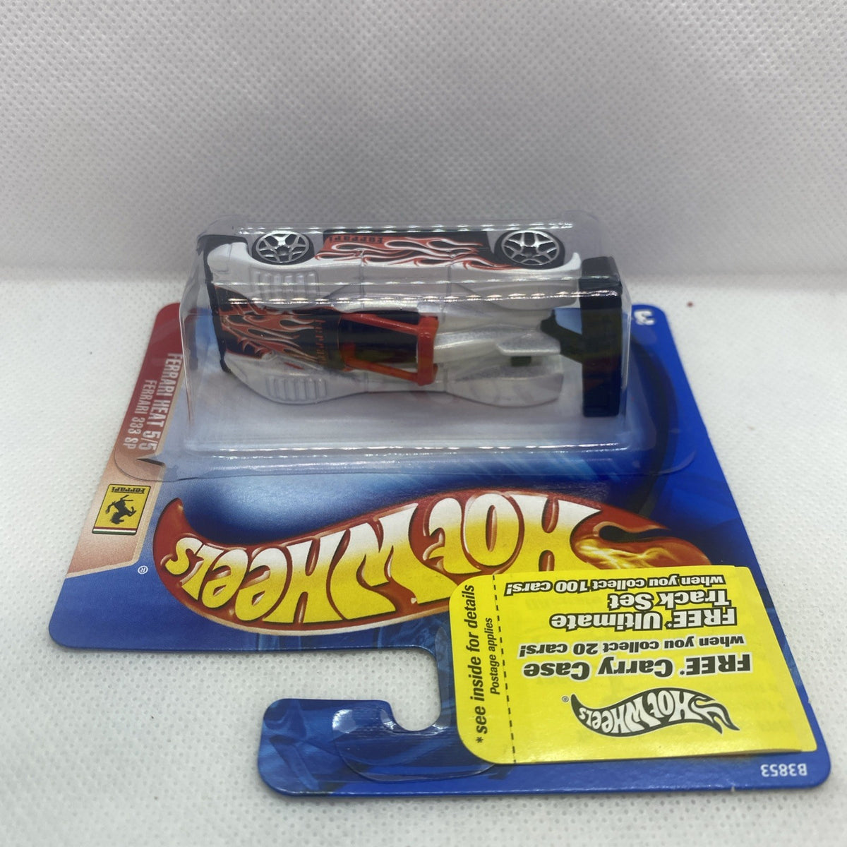 Die-cast race car in blister: white body with red flame graphics and black wheels
