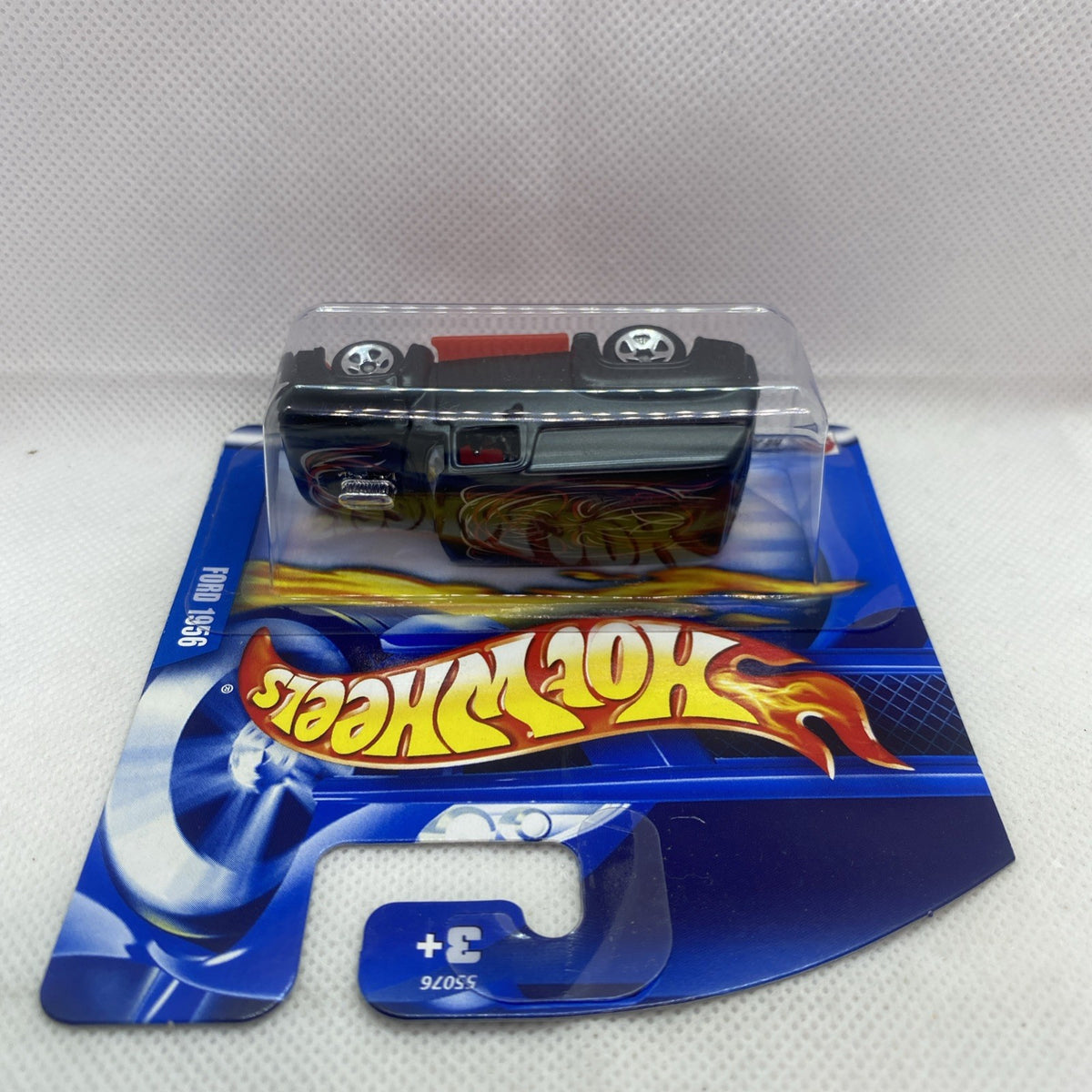 Hot Wheels die-cast truck in blister, top view, black cab with flame paint