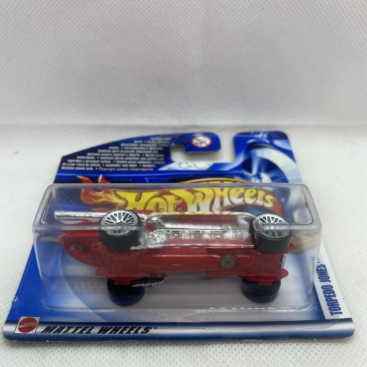 Hot Wheels torpedo car blister pack, front three-quarter view with chrome wheels