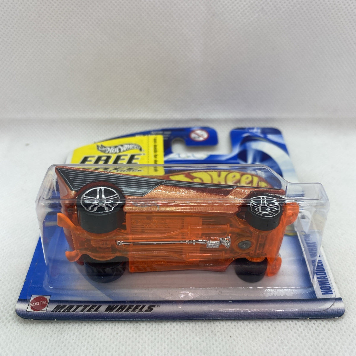 Hot Wheels orange-brown die-cast car in clear blister on short card with flame graphics