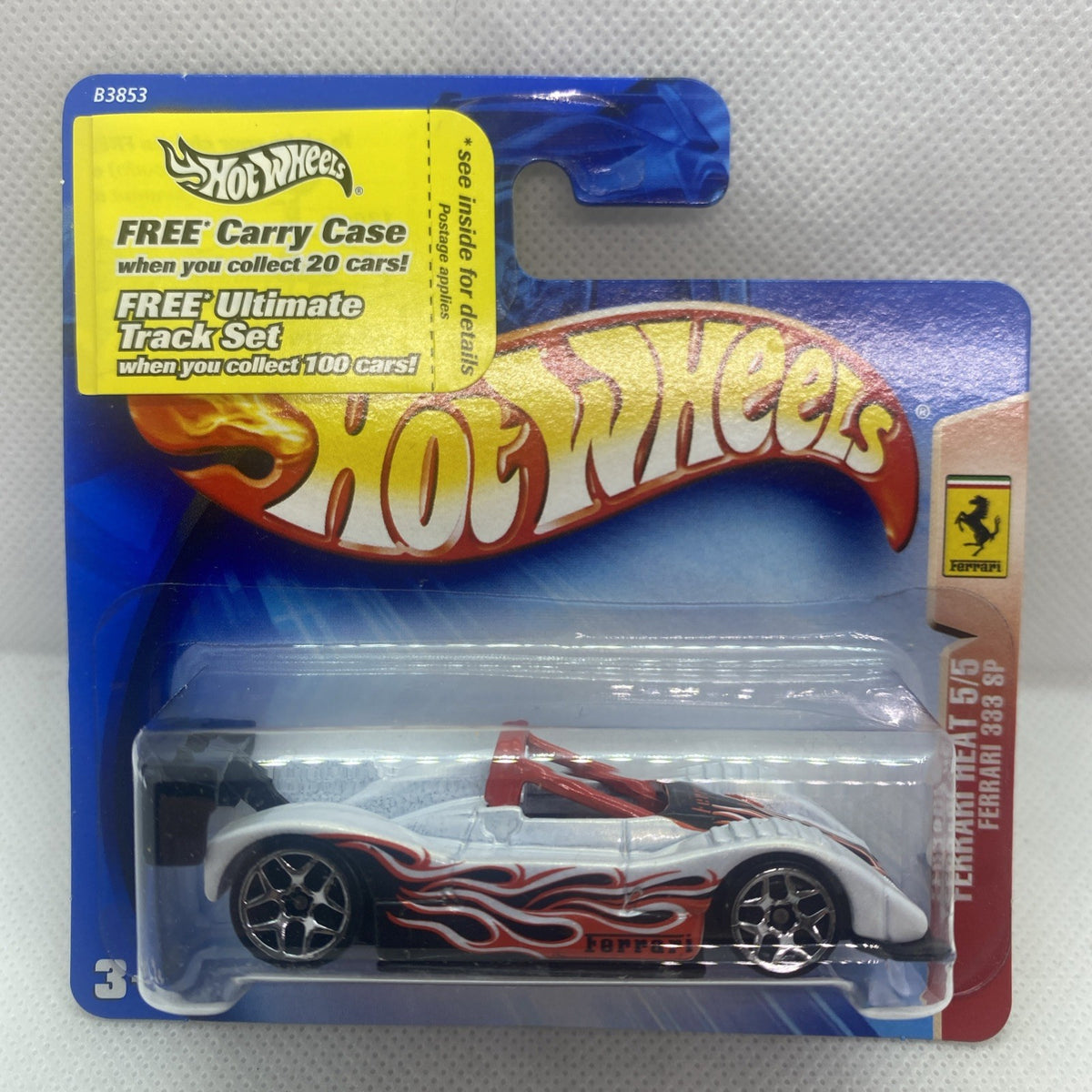 White Hot Wheels race car with red flame decals, black wheels, in blue blister pack