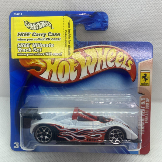 White Hot Wheels race car with red flame decals, black wheels, in blue blister pack