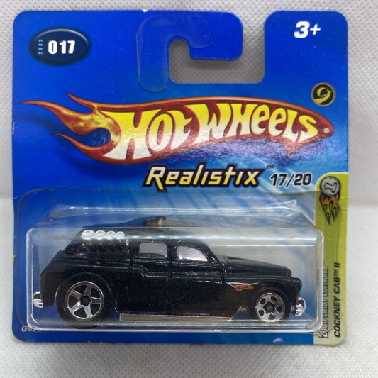 Hot Wheels die-cast car in clear blister pack on blue Realistix card