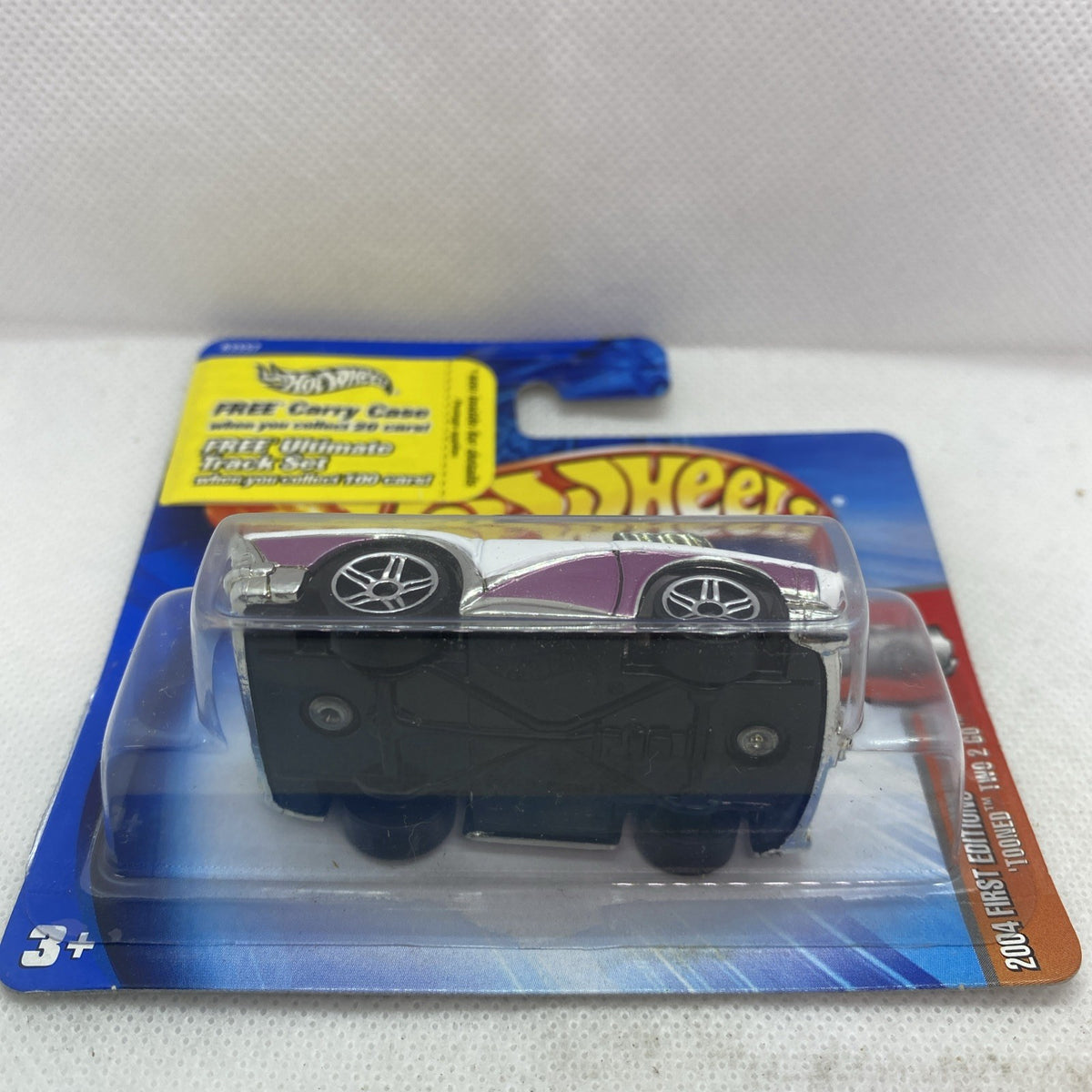 Packaged white and purple die-cast car with wheels visible under clear blister