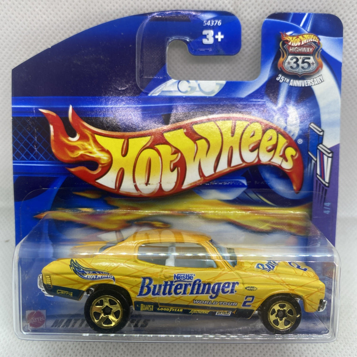 Hot Wheels die-cast yellow car in sealed blister pack, front view with flame graphics