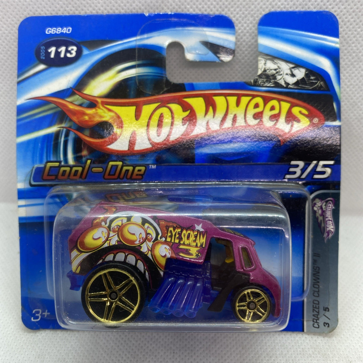 Hot Wheels Cool-One 2005 die-cast car on blue blister card, magenta with blue details