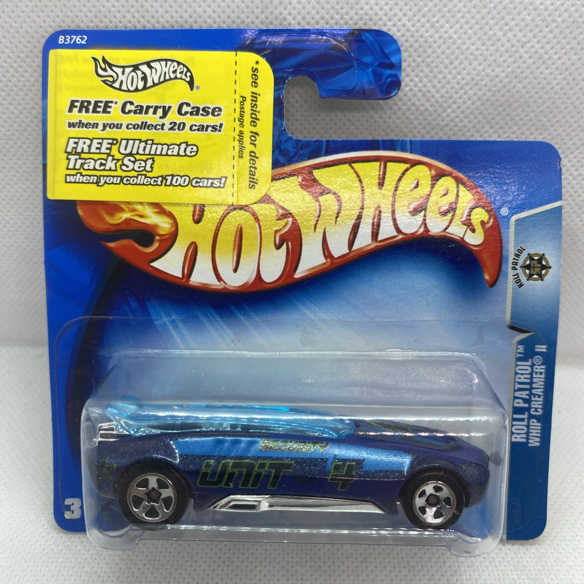 Hot Wheels card with yellow “Free Carrier Case” text and blue blister, sealed car inside