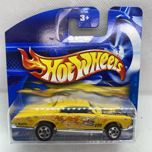 Yellow die-cast car in blue blister pack with Hot Wheels logo