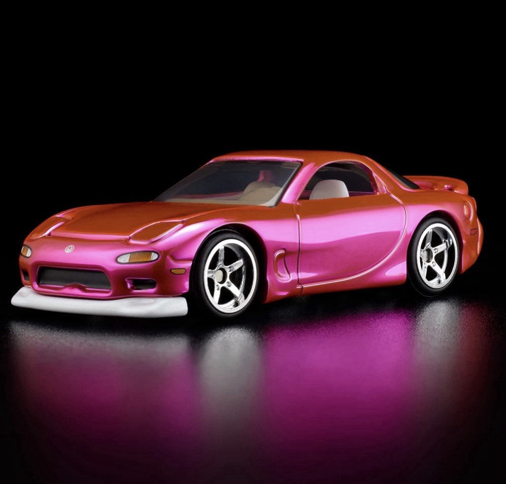 Pink and orange die-cast sports car with chrome wheels, front 3/4 view