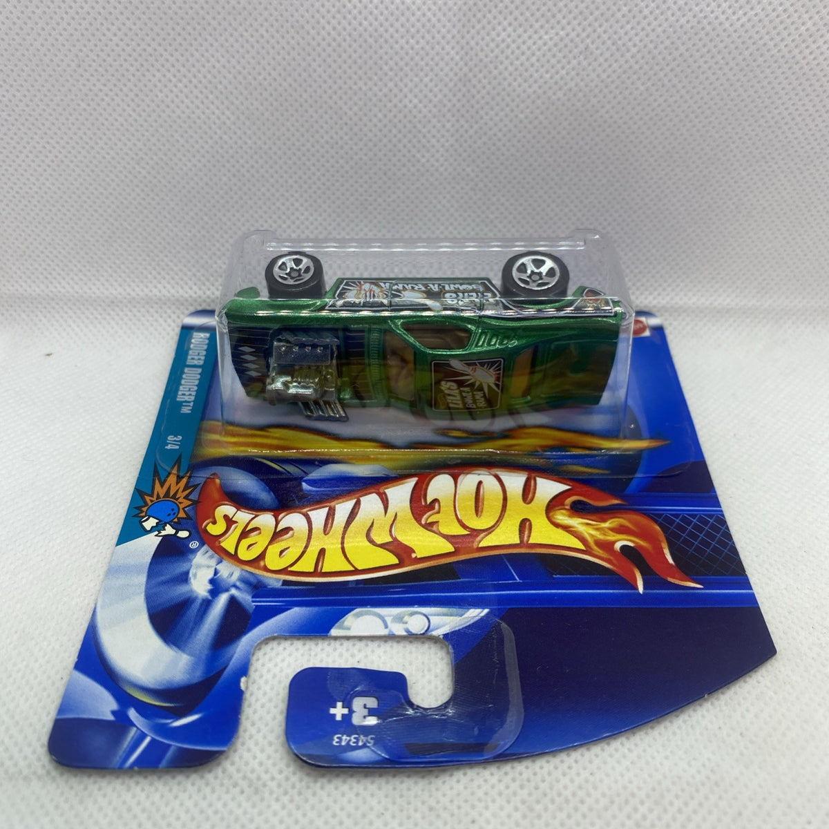 Green Hot Wheels die-cast car in clear blister on blue card, top view