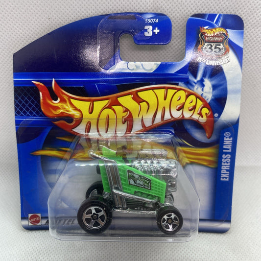 Green and black Hot Wheels toy car on blue blister card packaging