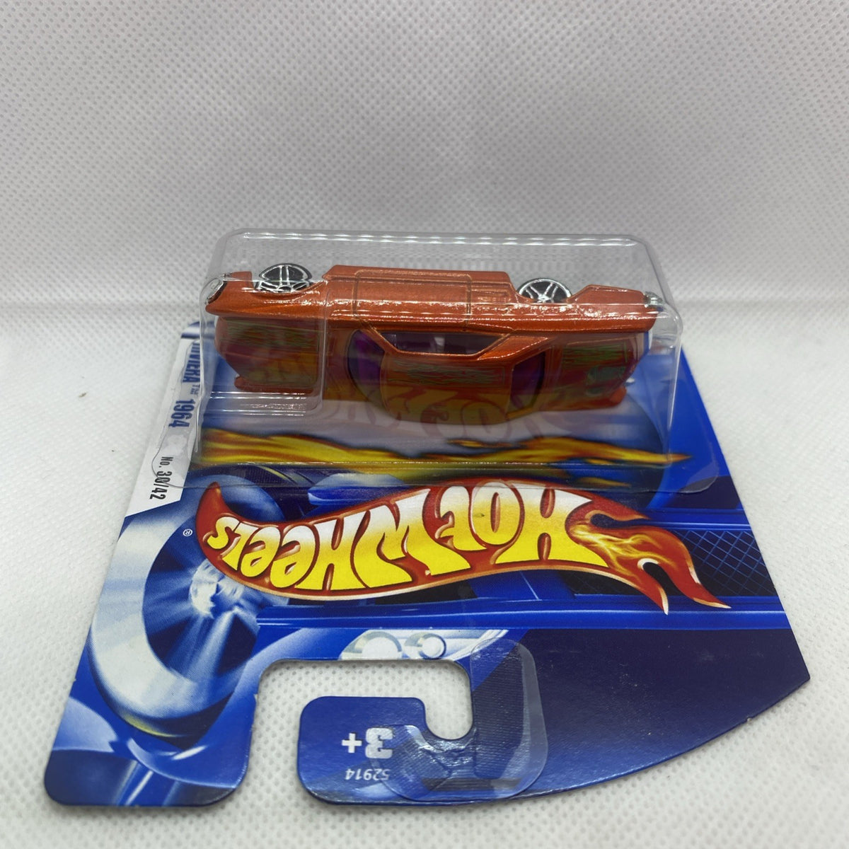 Orange die-cast car in clear blister pack on Hot Wheels card, top-down view