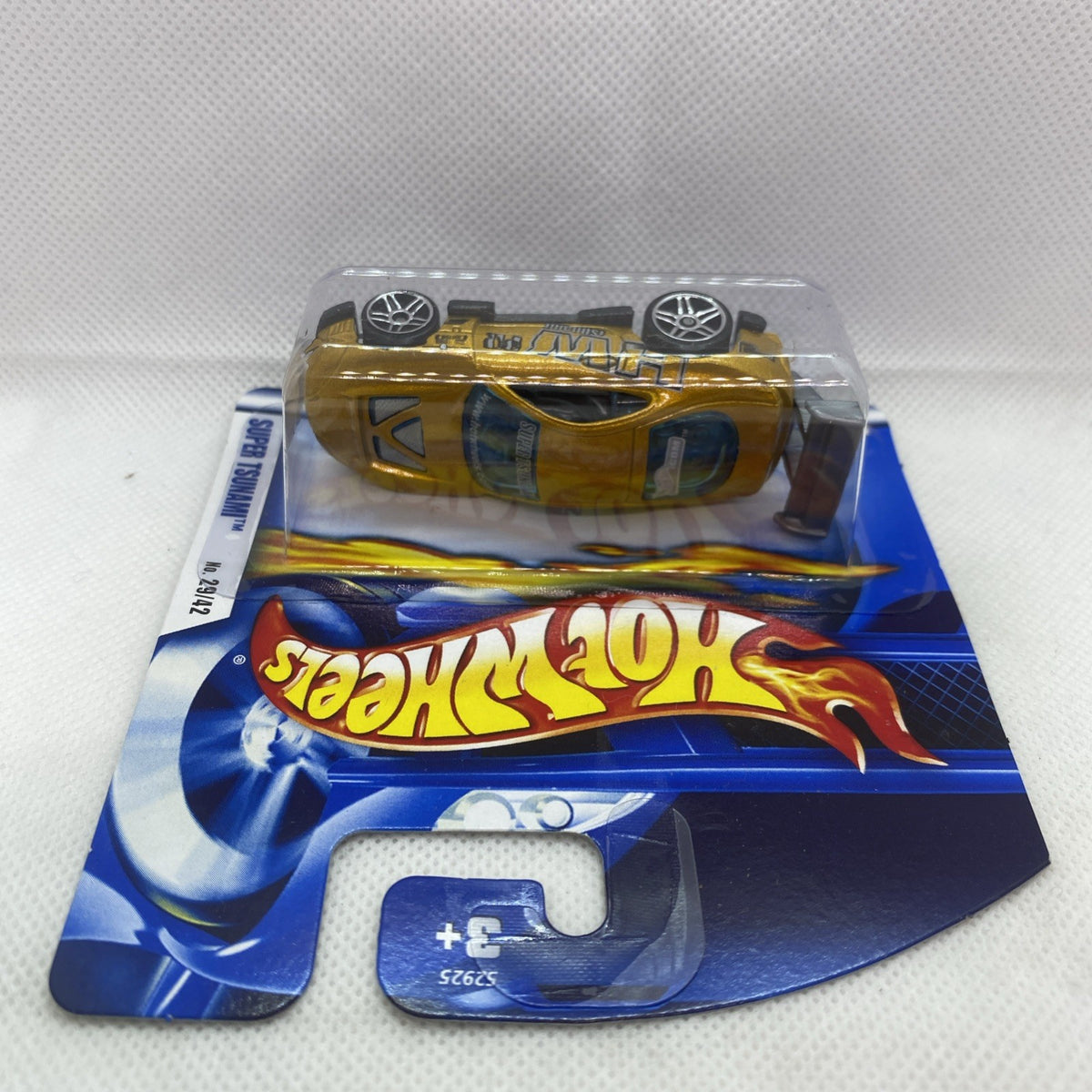 Hot Wheels Super Tsunami die-cast car in sealed short card blister, gold with flame decals