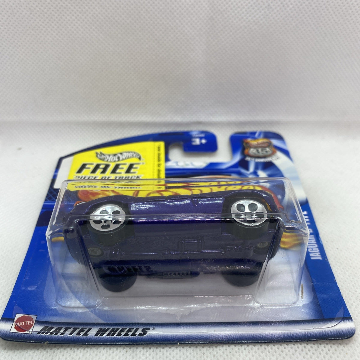 Dark blue Jaguar D-Type die-cast car in clear blister on blue card