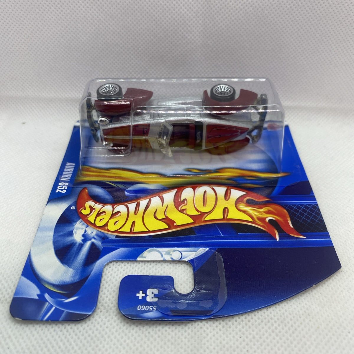 Hot Wheels Auburn 852 die-cast car on blue card backing, clear blister front