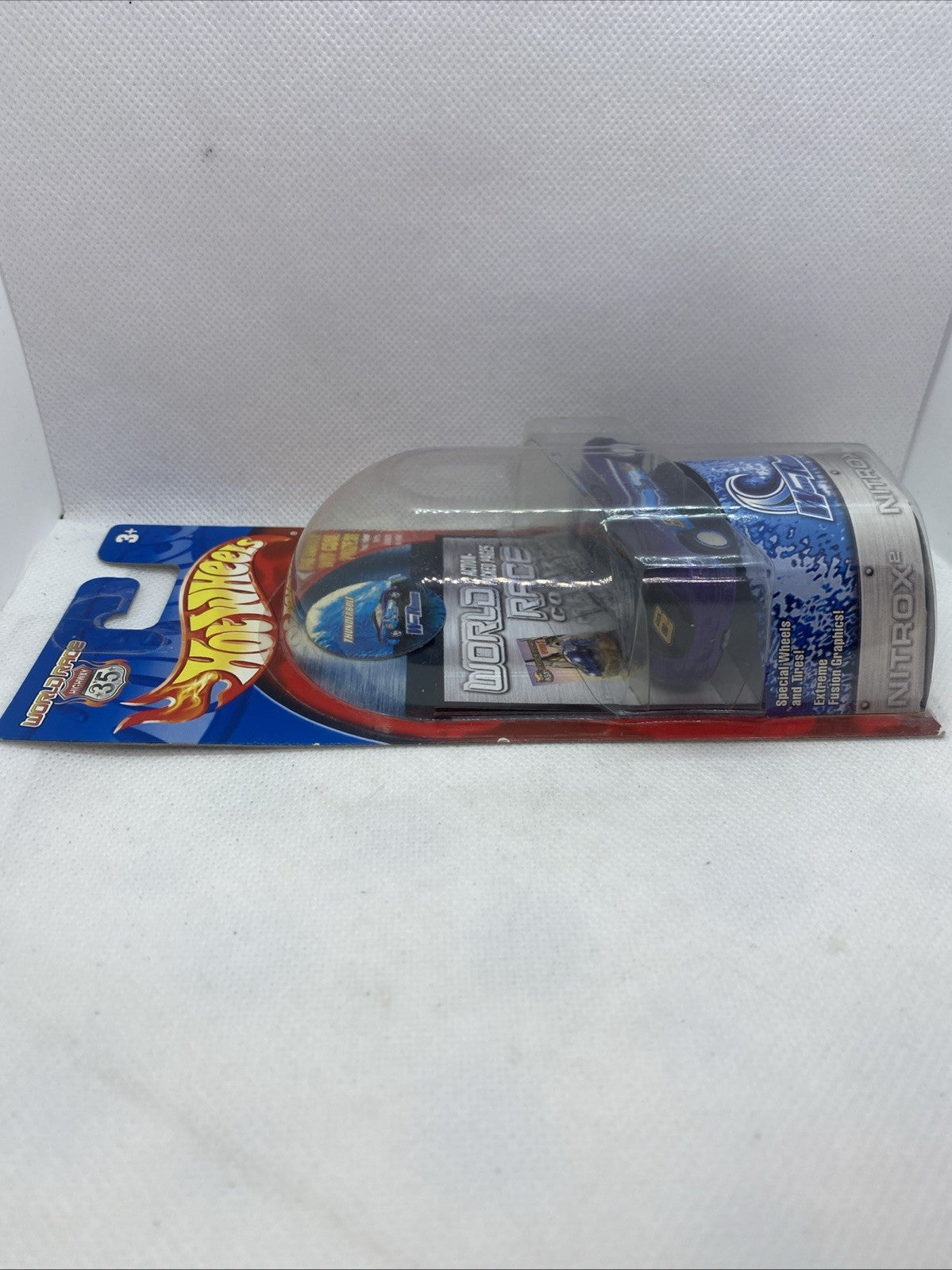 Hot Wheels World Race die-cast car in blister pack, angled side view