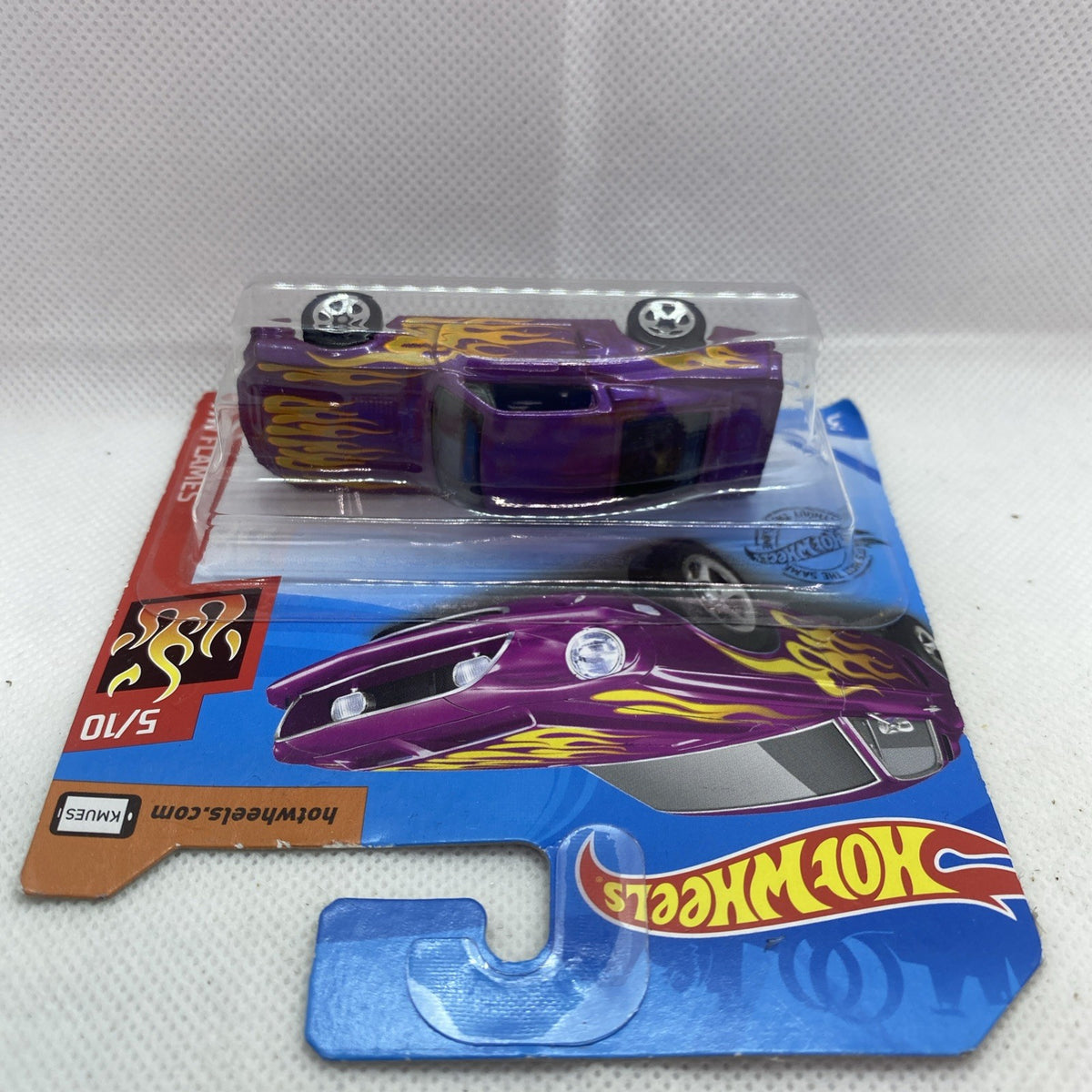 Hot Wheels die-cast car blister showing purple flame design and clear window packaging