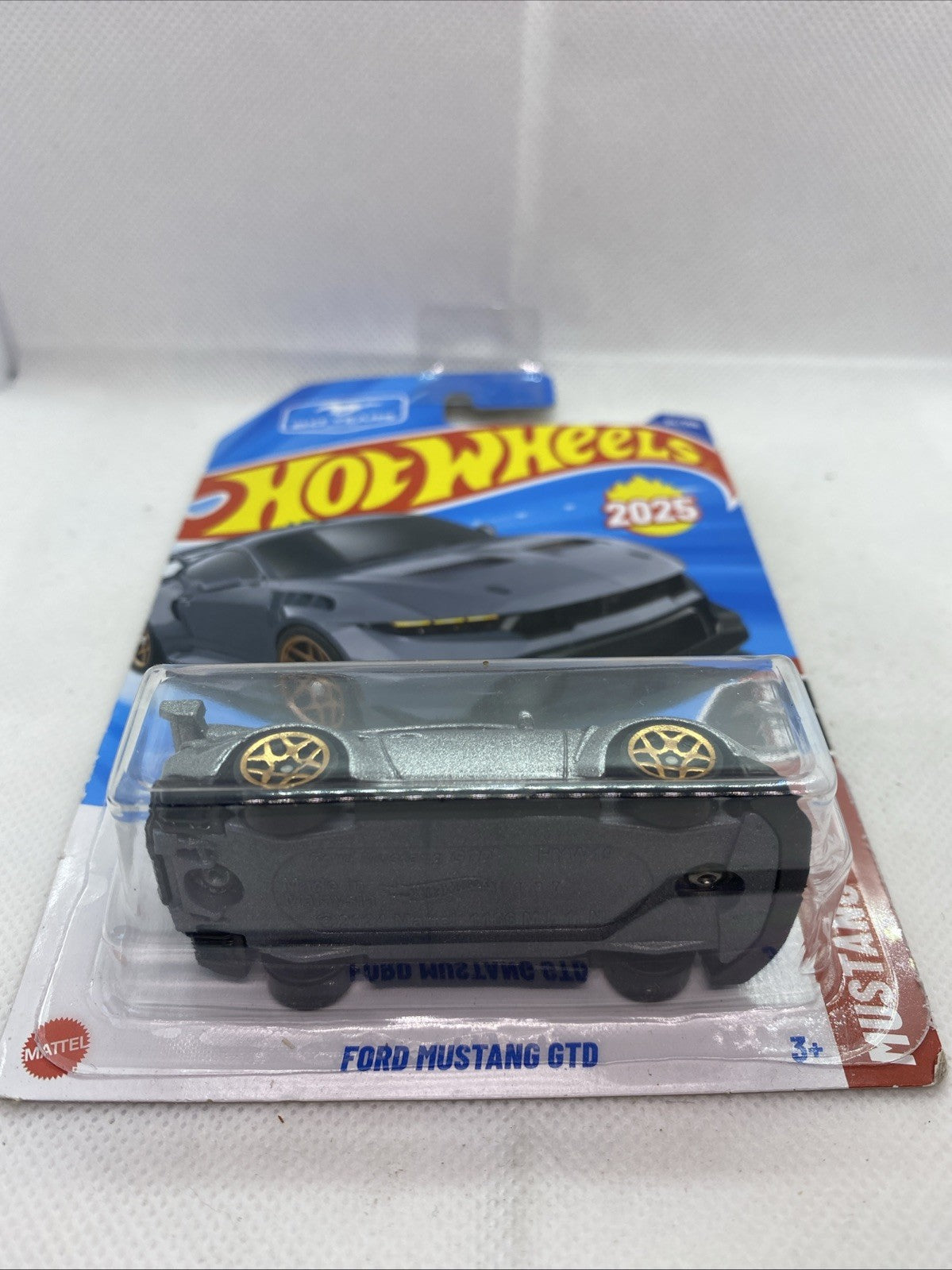 Hot Wheels Ford Mustang GTD 2025 die-cast, silver body with black grille, gold wheels