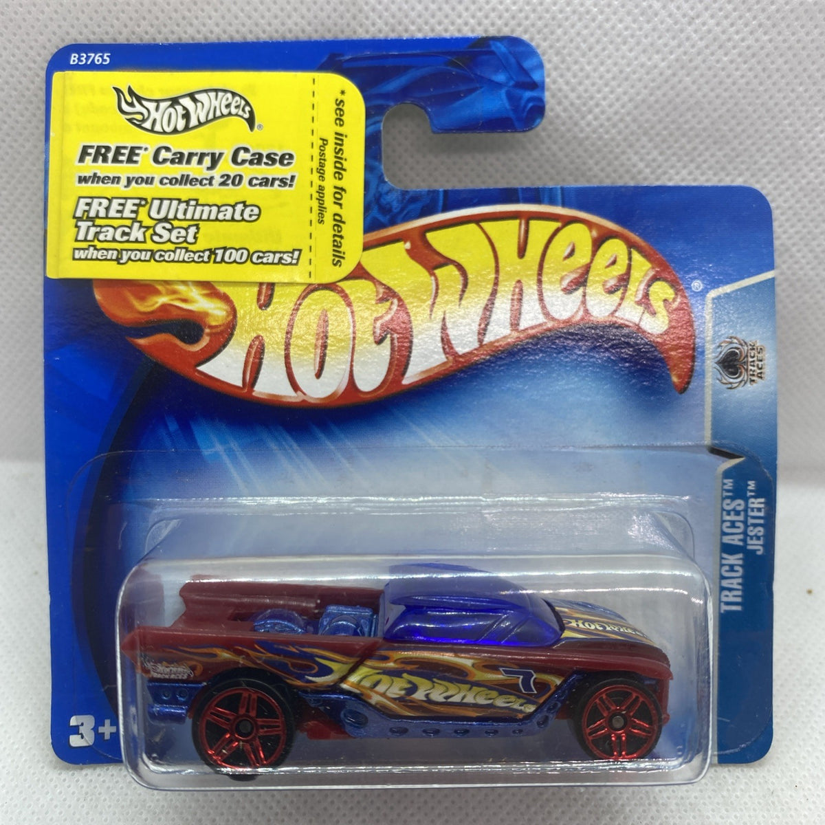 Hot Wheels race car on blister card: maroon body, blue flames, red wheels.