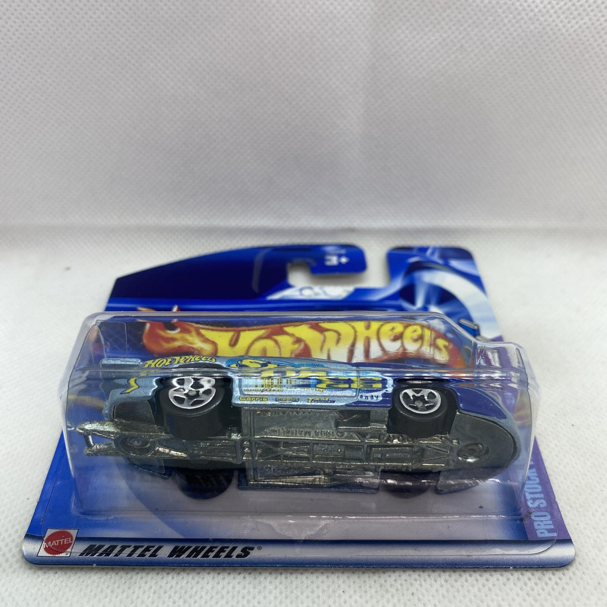Hot Wheels die-cast car in sealed blister, black wheels and gray body