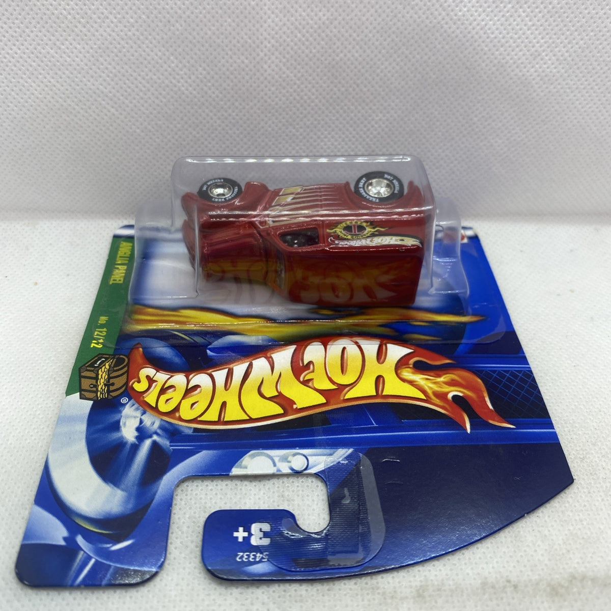Hot Wheels red panel van in blister package, viewed from a slight side angle