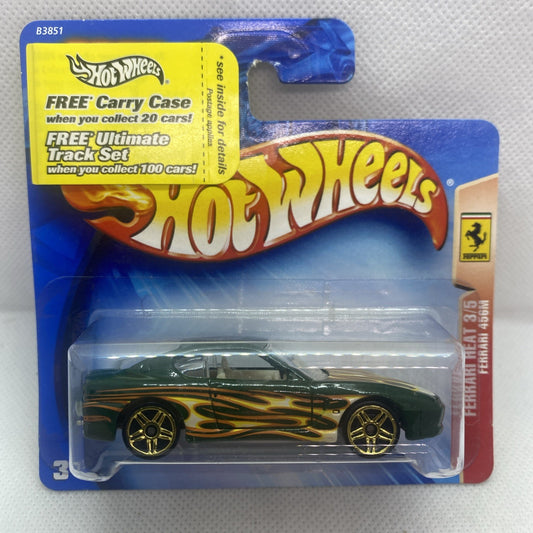 Die-cast sports car, green with gold flame graphics, on Hot Wheels card packaging