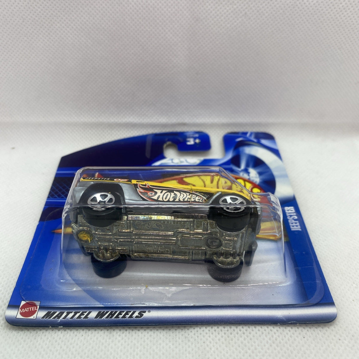 Hot Wheels Jeepster 2002 die-cast car front view in clear blister on blue card