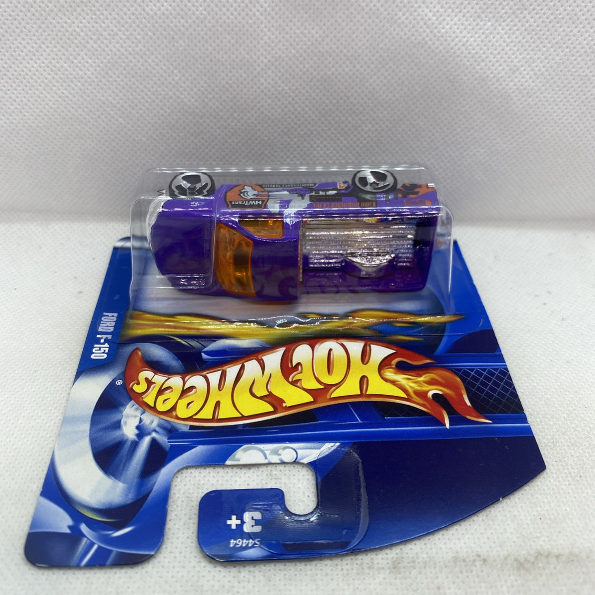 Hot Wheels purple 2002 Ford F-150 blister close-up, front cab and hood detail
