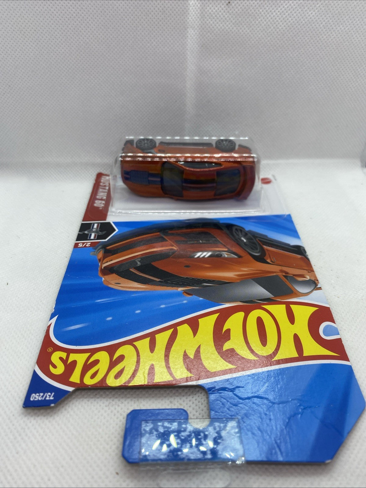 Hot Wheels die-cast car and blue card insert, orange Mustang Shelby GT500.