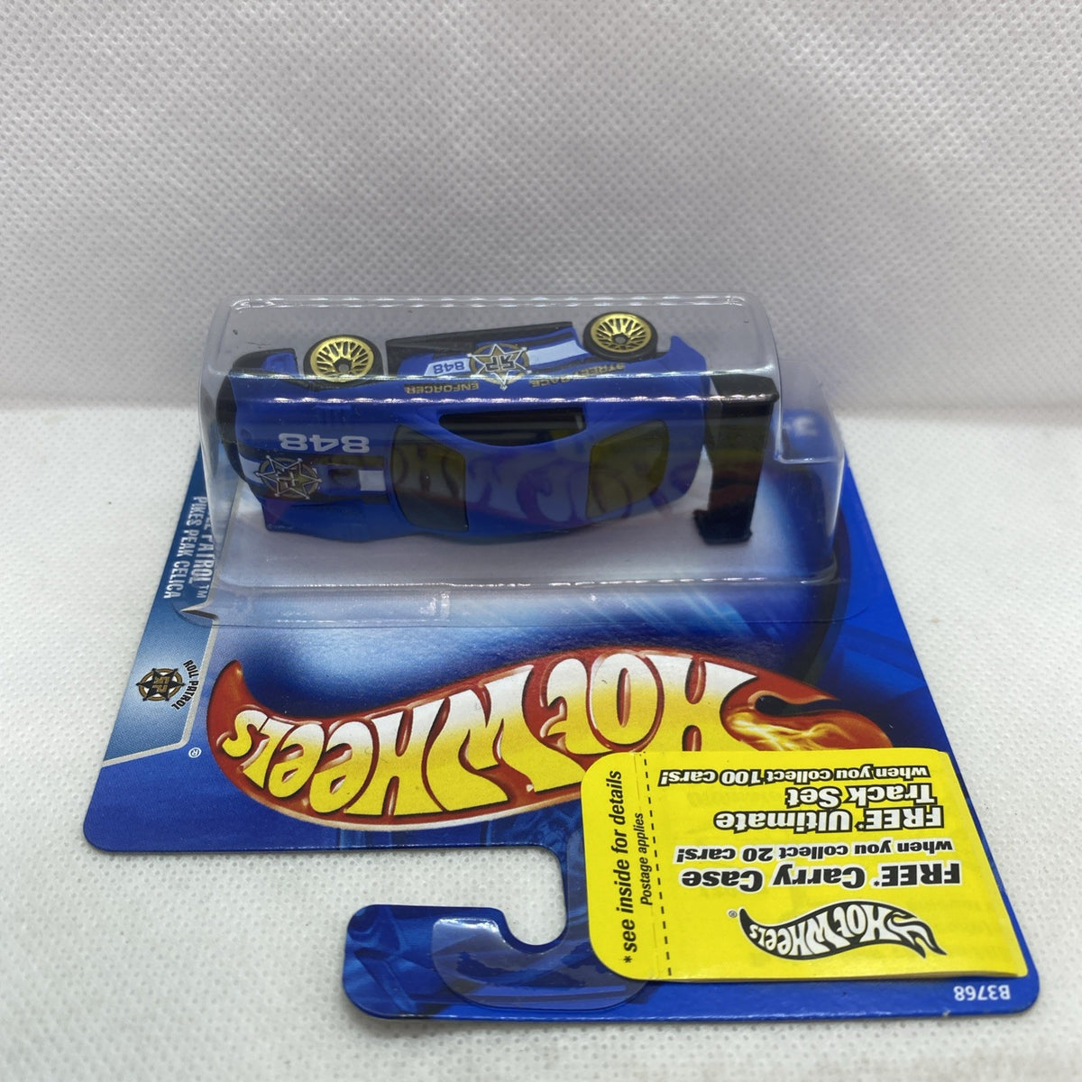 Hot Wheels blue die-cast car in clear blister on card, angled side view