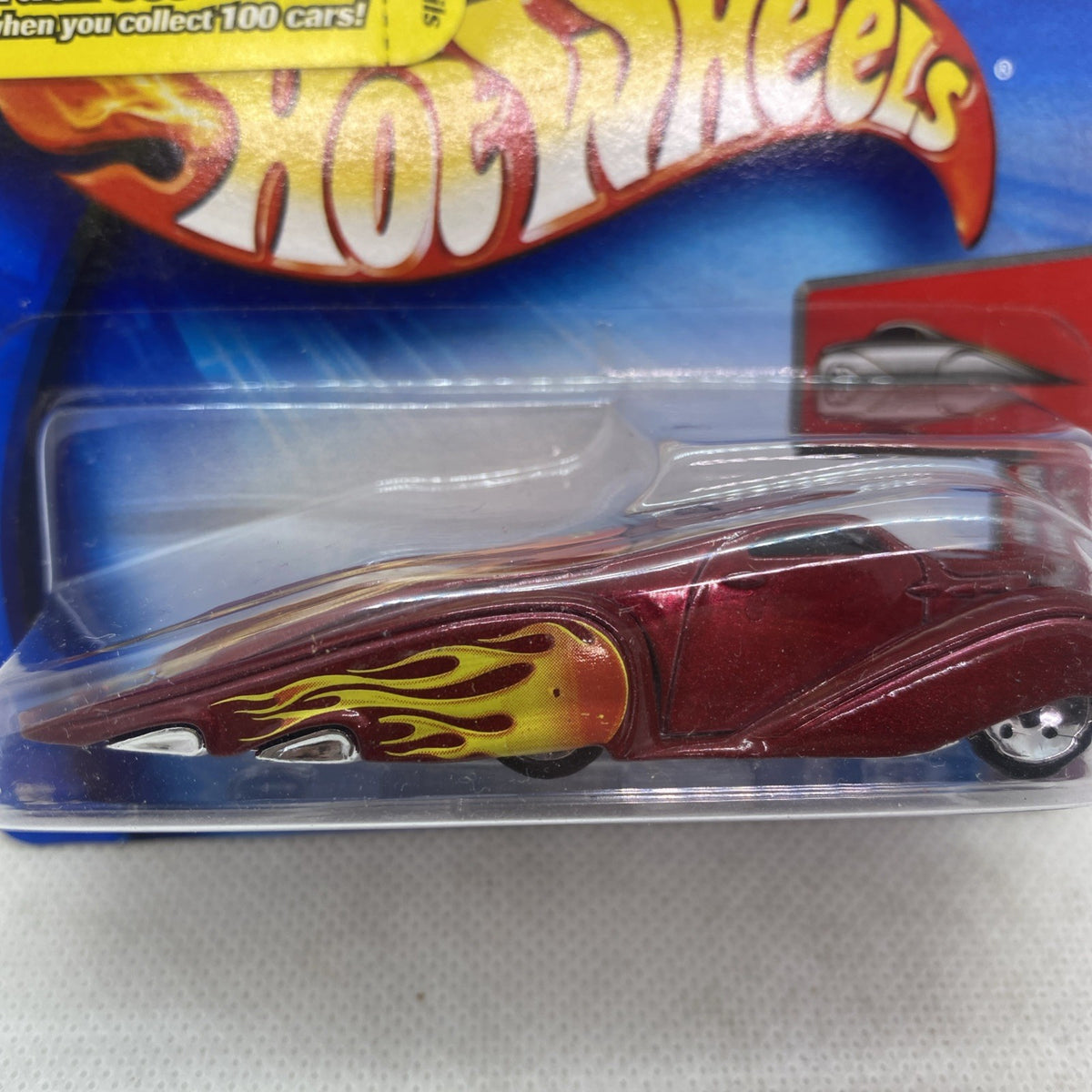 Hot Wheels burgundy flame coupe close-up in clear blister pack