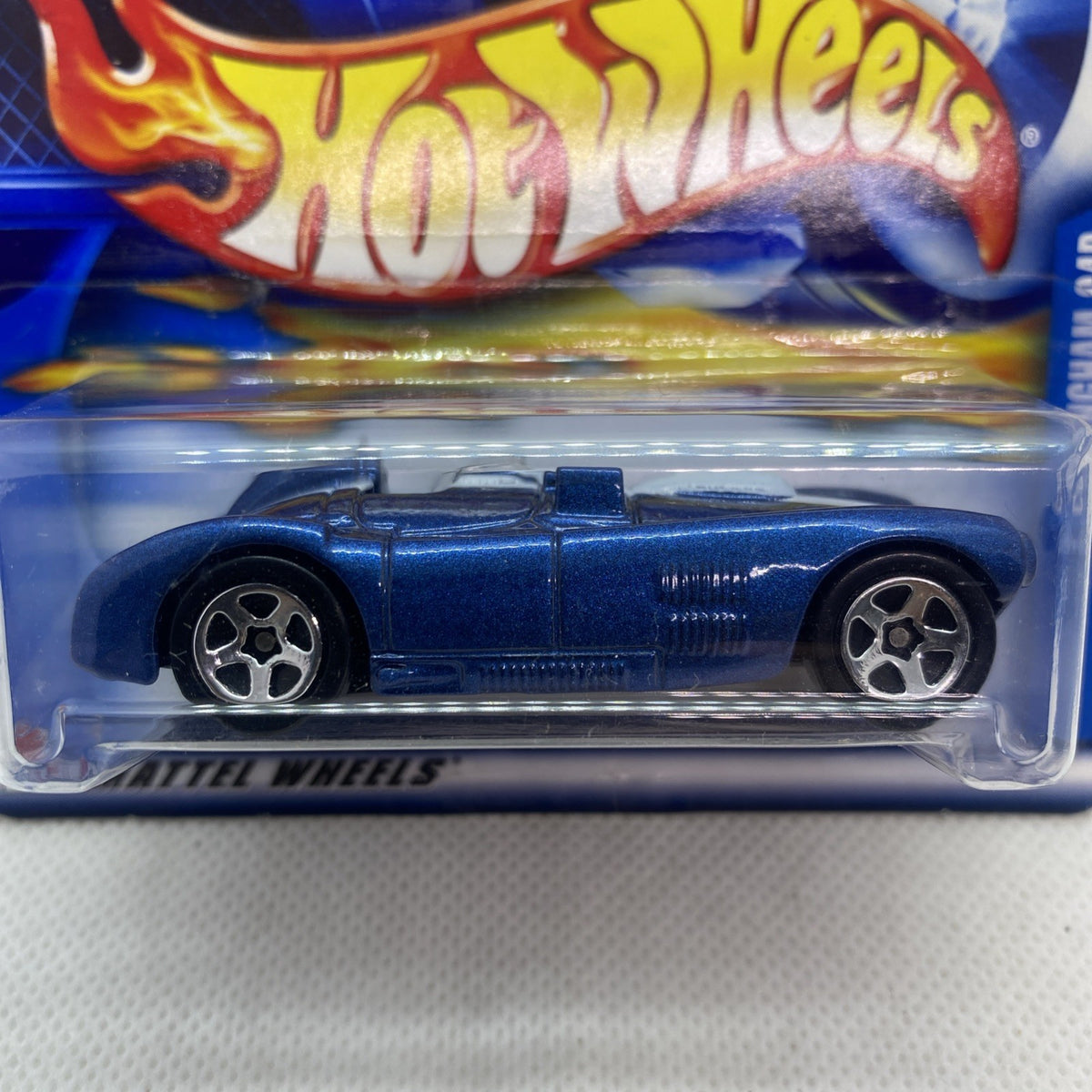 Close-up of blue Hot Wheels Cunningham C4R 2002 die-cast car in clear blister