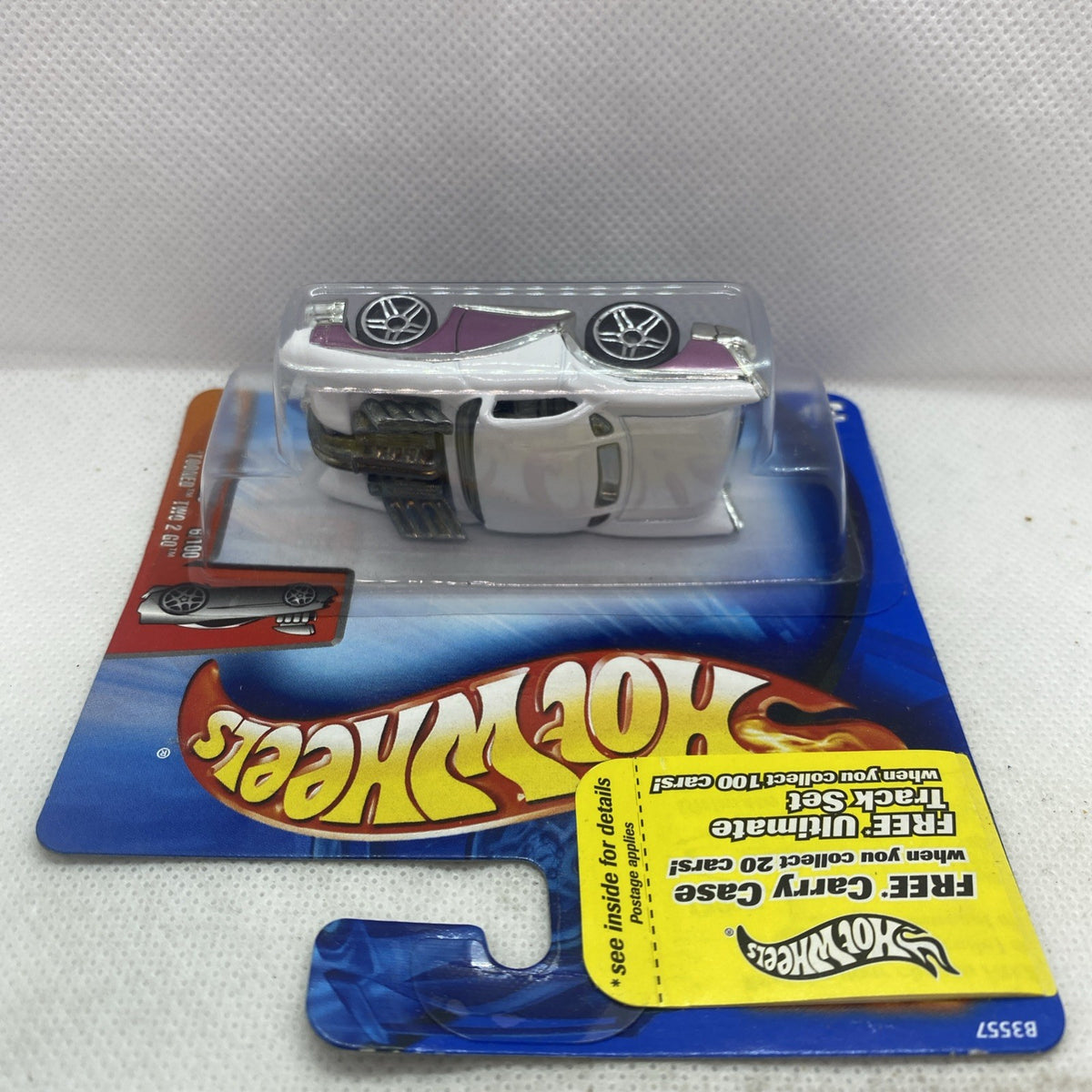 White and purple die-cast car in clear blister, shown from the side on the card