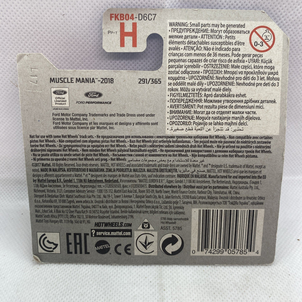 Hot Wheels toy car package back with warning panel, barcode, and vehicle details label