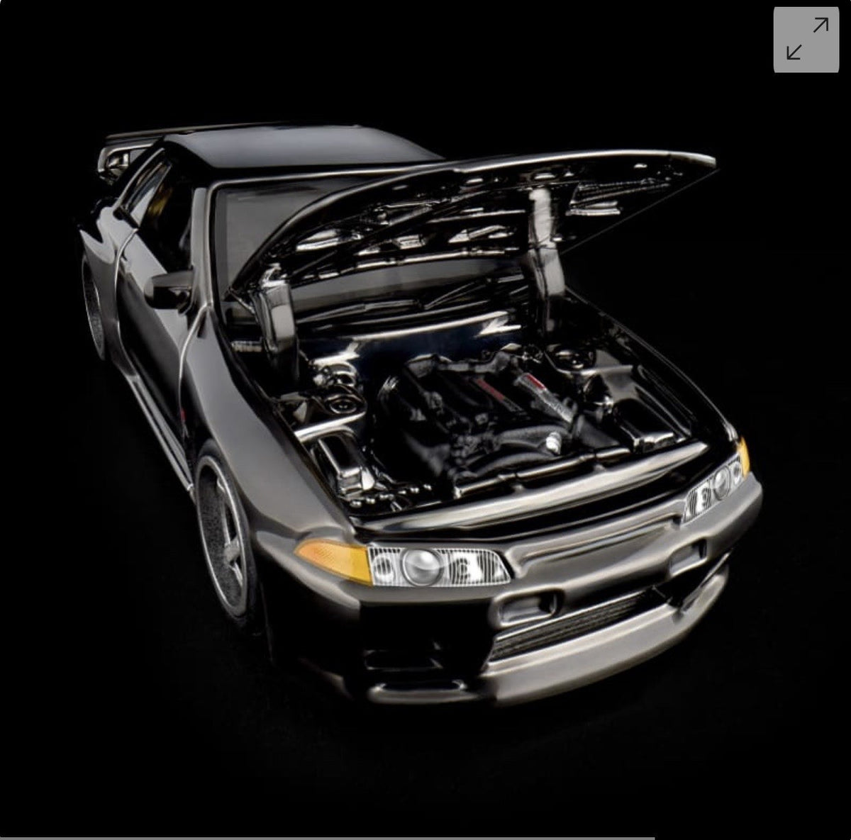 Die-cast sports car model, front-left view with open hood and detailed engine bay