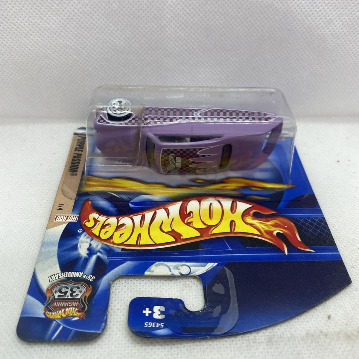 Hot Wheels die-cast car in clear blister, purple toy car with checkered front panel