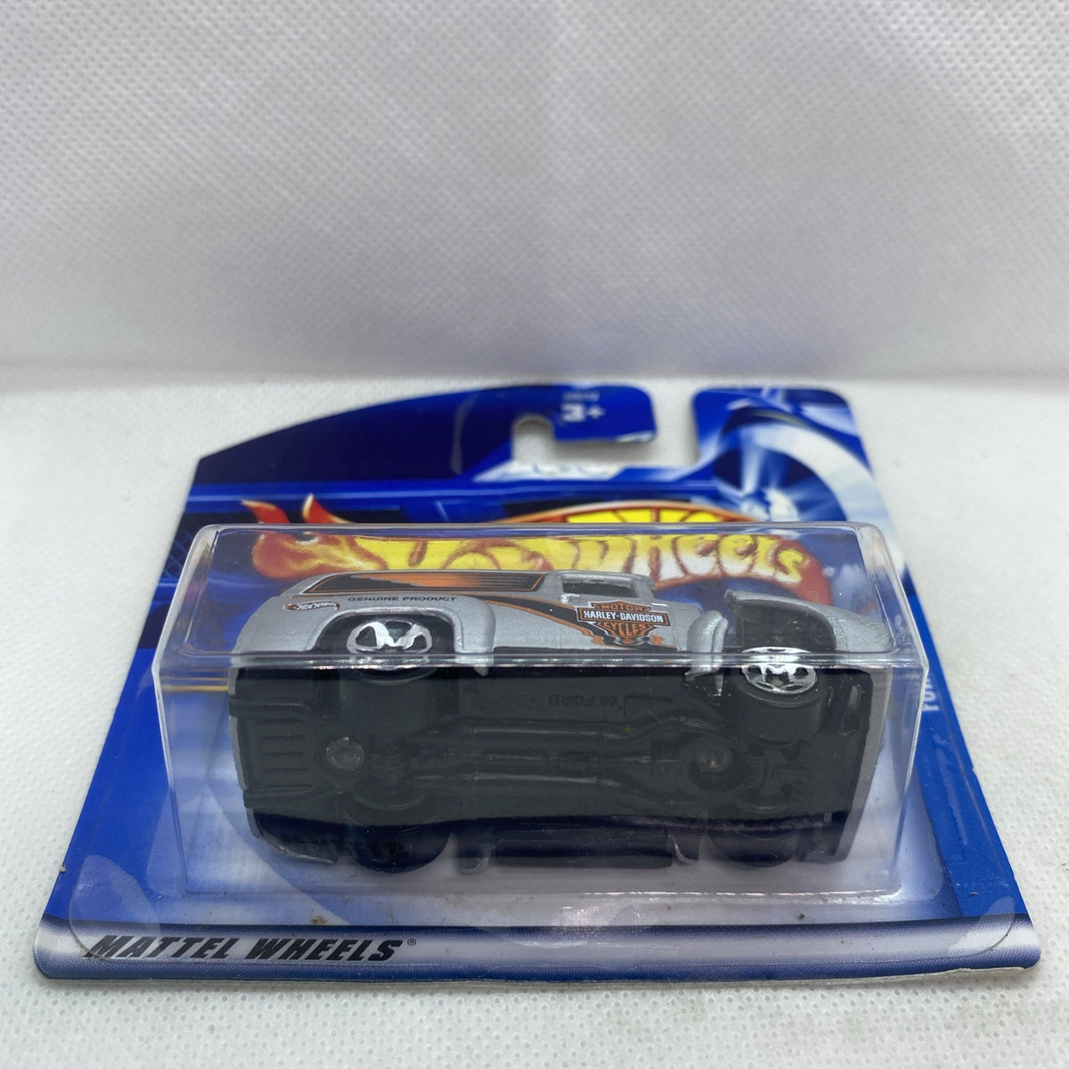 Hot Wheels car in blister pack on blue card with silver-and-black truck design
