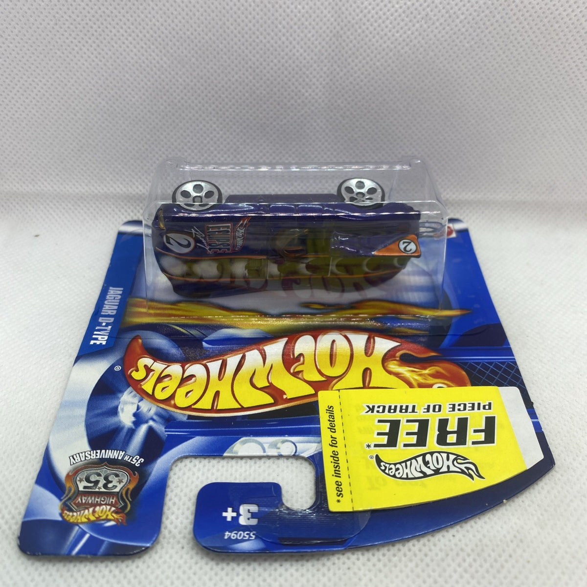 Blue Hot Wheels card with dark blue Jaguar D-Type die-cast car in clear blister