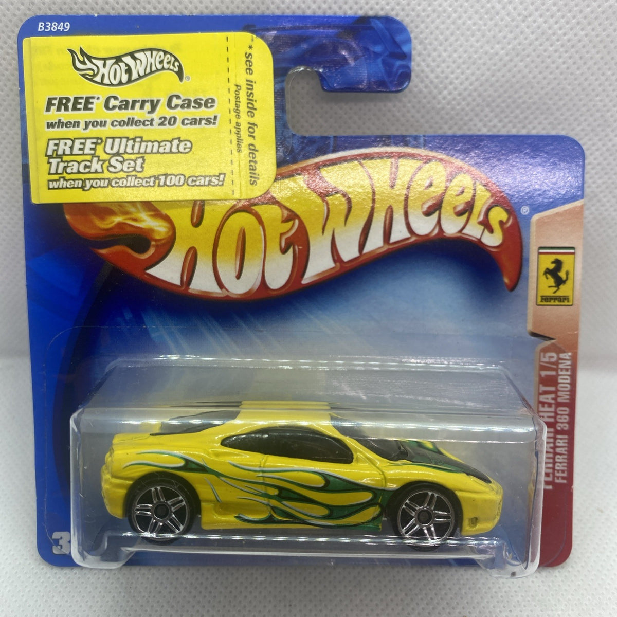 Yellow die-cast race car with green flame graphics on Hot Wheels card blister pack