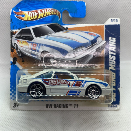 Hot Wheels 92 Ford Mustang die-cast car on sealed short card, white and blue