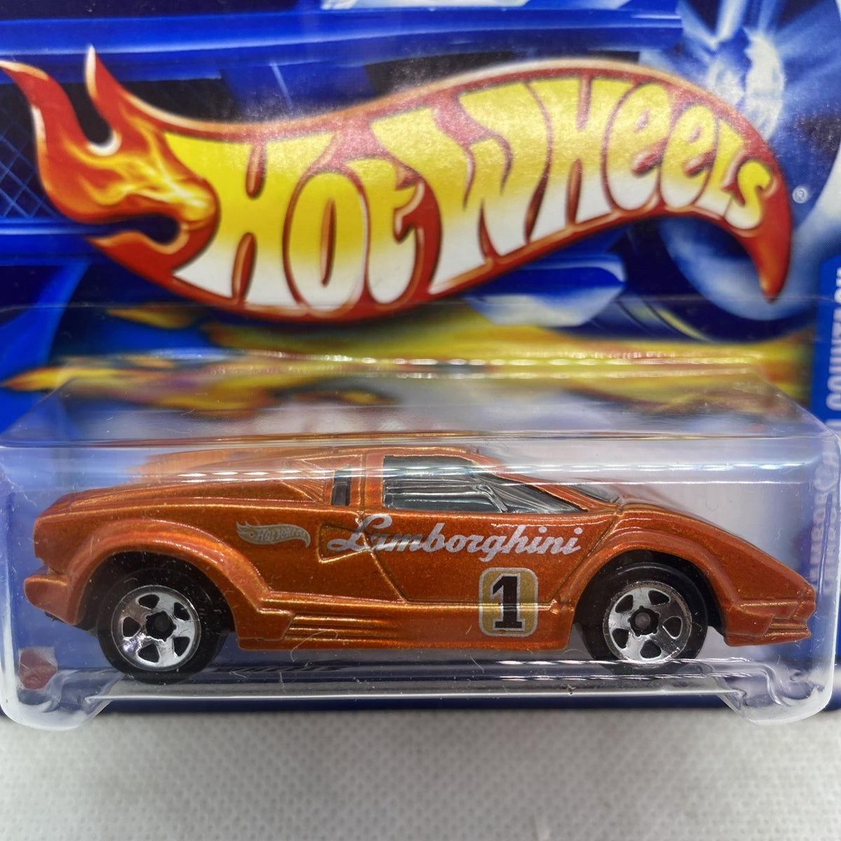 Hot Wheels Lamborghini Countach die-cast car close-up in blue blister, orange body
