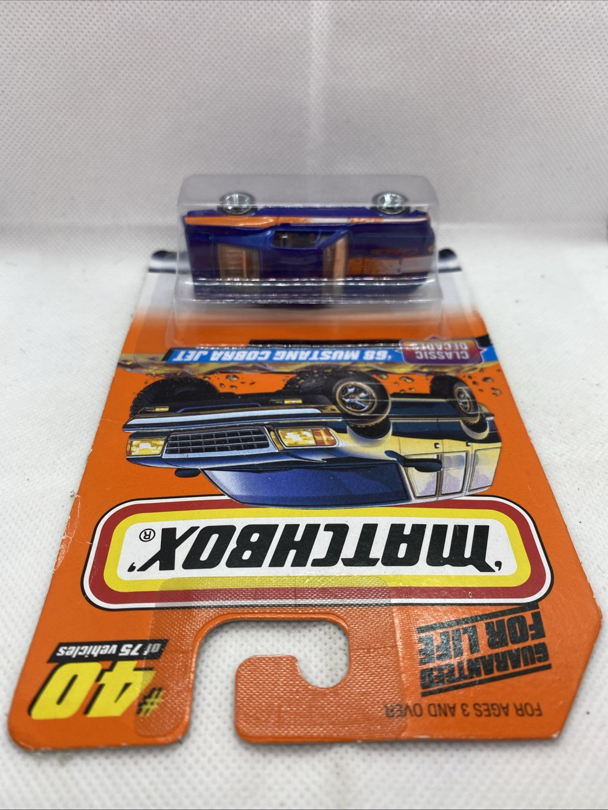 Sealed Matchbox blister package showing blue '68 Mustang Cobra Jet car from underside