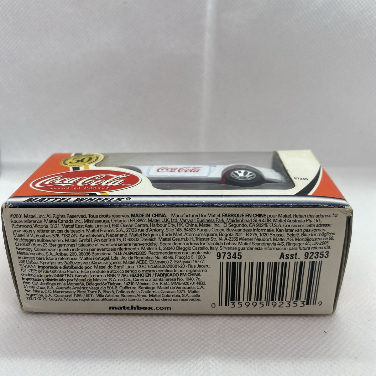 Box underside of boxed die-cast car with barcode, codes, and packaging labels