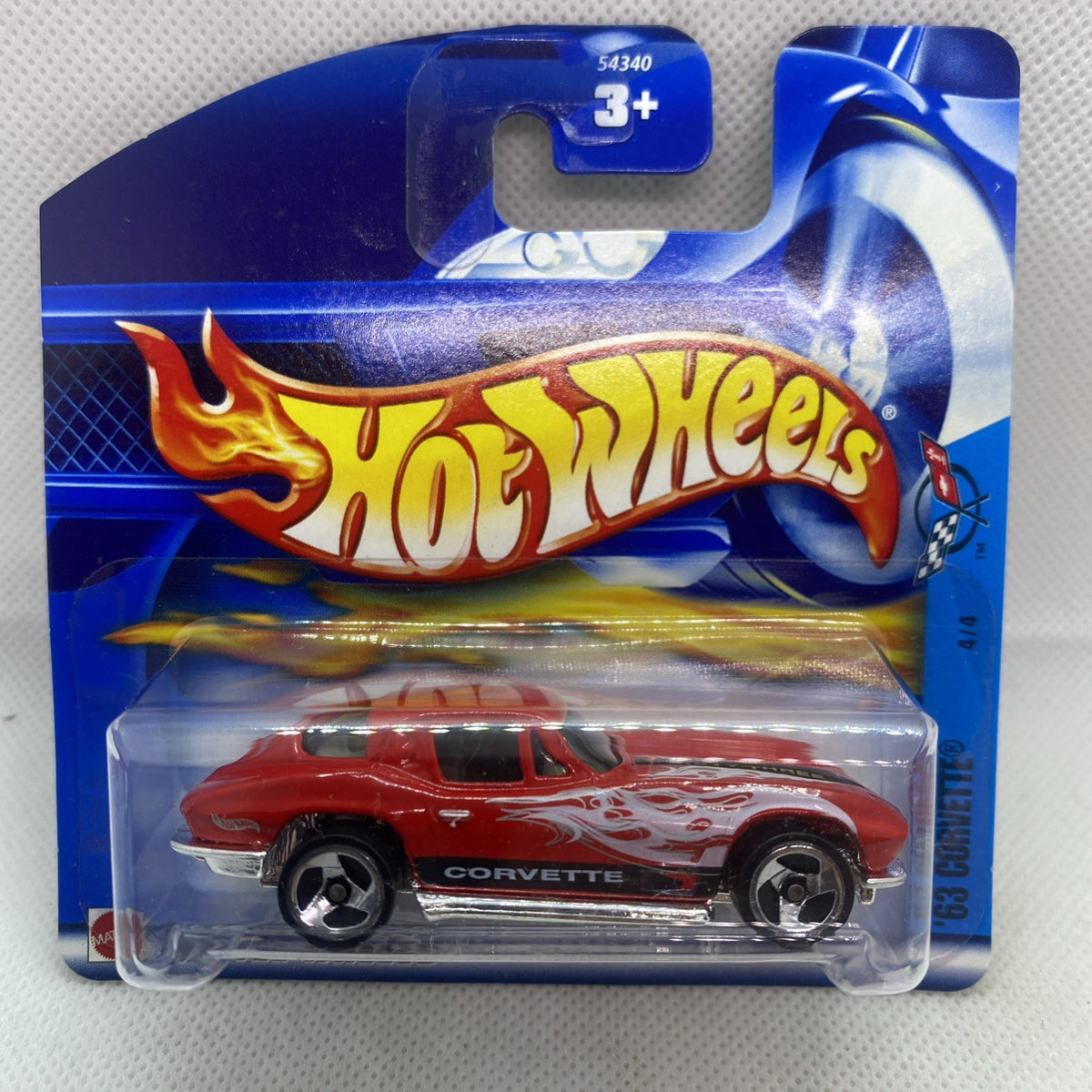 Hot Wheels Corvette die-cast in blue blister, red with white flame graphics